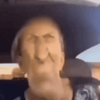 A Close Up Of A Man 'S Face In A Car . GIF