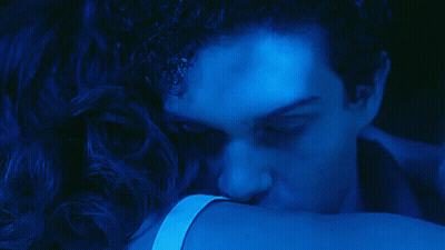 A Close Up Of A Man 'S Face In A Dark Blue Light GIF