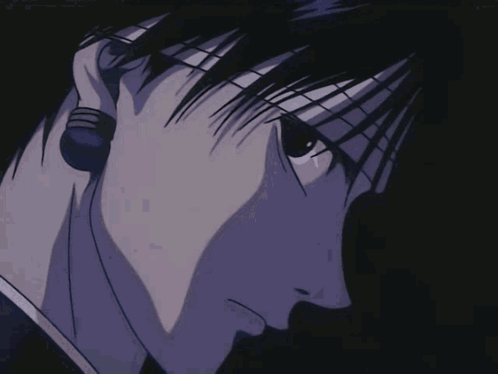 A Close Up Of A Man 'S Face In A Dark Room GIF