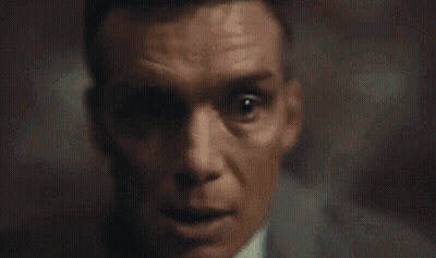 A Close Up Of A Man 'S Face In A Dark Room . GIF