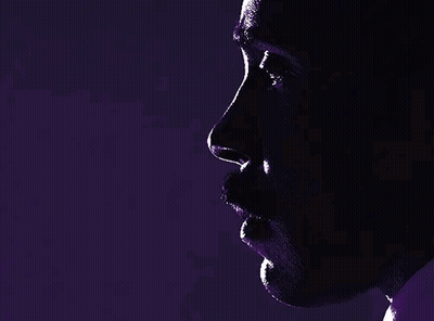 A Close Up Of A Man 'S Face In A Dark Room GIF