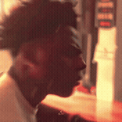 A Close Up Of A Man 'S Face In A Dark Room . GIF