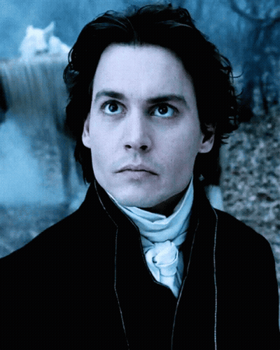 A Close Up Of A Man 'S Face In A Dark Room GIF