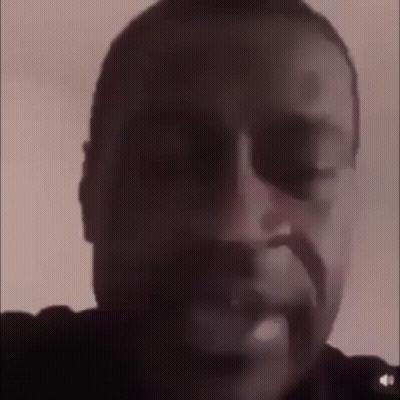 A Close Up Of A Man 'S Face In A Dark Room . GIF
