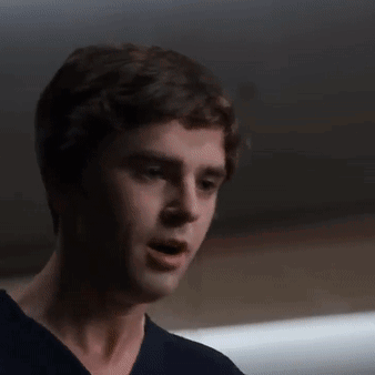 A Close Up Of A Man 'S Face In A Dark Room . GIF