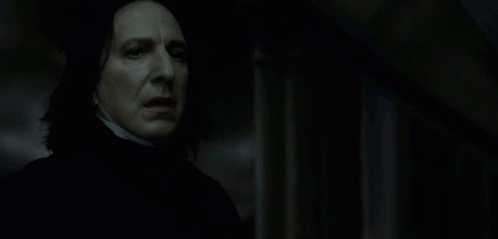 A Close Up Of A Man 'S Face In A Dark Room . GIF