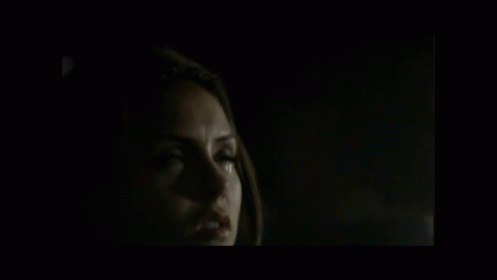 A Close Up Of A Man 'S Face In A Dark Room . GIF