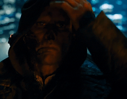 A Close Up Of A Man 'S Face In A Dark Room GIF
