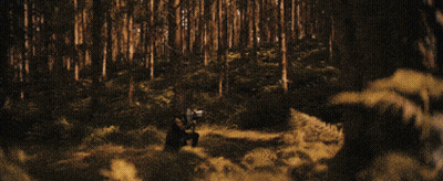 A Close Up Of A Man 'S Face In A Dark Room With A Backpack . GIF