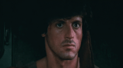 A Close Up Of A Man 'S Face In A Dark Room With A Beard . GIF