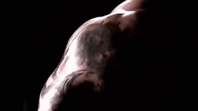 A Close Up Of A Man 'S Face In A Dark Room With A Black Background . GIF