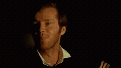 A Close Up Of A Man 'S Face In A Dark Room With A Black Background . GIF