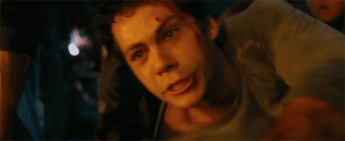 A Close Up Of A Man 'S Face In A Dark Room With A Blurred Background . GIF