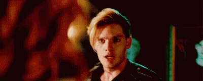 A Close Up Of A Man 'S Face In A Dark Room With A Blurred Background . GIF