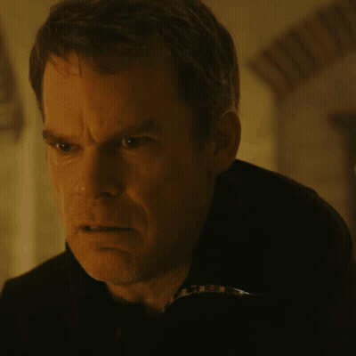 A Close Up Of A Man 'S Face In A Dark Room With A Blurry Background GIF