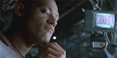 A Close Up Of A Man 'S Face In A Dark Room With A Camera In The Background . GIF