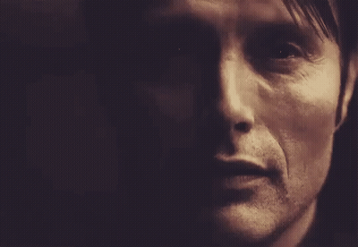 A Close Up Of A Man 'S Face In A Dark Room With A Dark Background . GIF