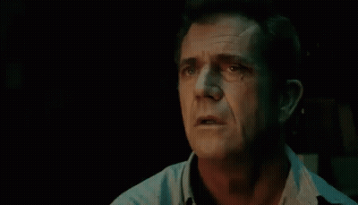 A Close Up Of A Man 'S Face In A Dark Room With His Eyes Closed And His Mouth Open . GIF