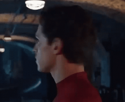 A Close Up Of A Man 'S Face In A Red Spiderman Suit . GIF