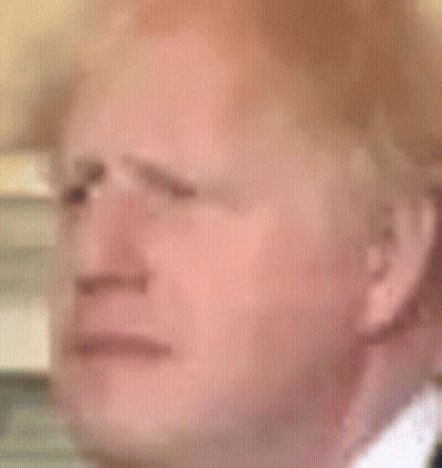 A Close Up Of A Man 'S Face In A Suit And Tie With A Serious Look On His Face . GIF