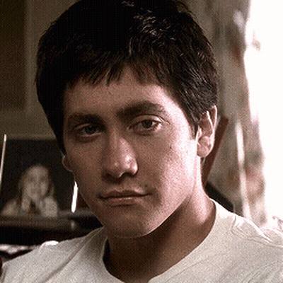 A Close Up Of A Man 'S Face In A White Shirt GIF