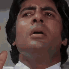 A Close Up Of A Man 'S Face In A White Shirt And Tie . GIF