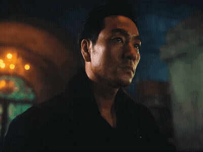A Close Up Of A Man 'S Face In Front Of A Fire GIF