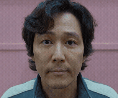 A Close Up Of A Man 'S Face In Front Of A Pink Wall GIF