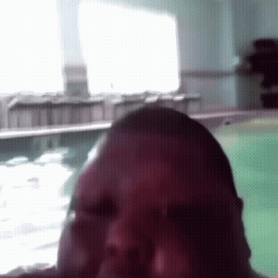 A Close Up Of A Man 'S Face In Front Of A Swimming Pool . GIF