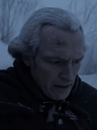 A Close Up Of A Man 'S Face In The Dark GIF