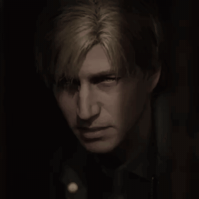 A Close Up Of A Man 'S Face In The Dark GIF