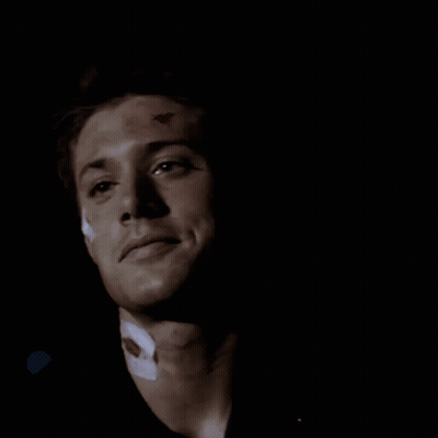 A Close Up Of A Man 'S Face In The Dark GIF
