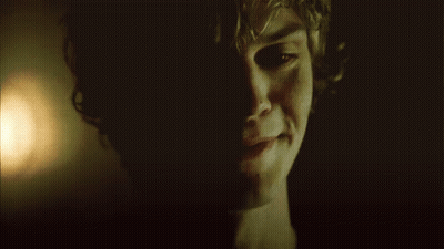 A Close Up Of A Man 'S Face In The Dark GIF
