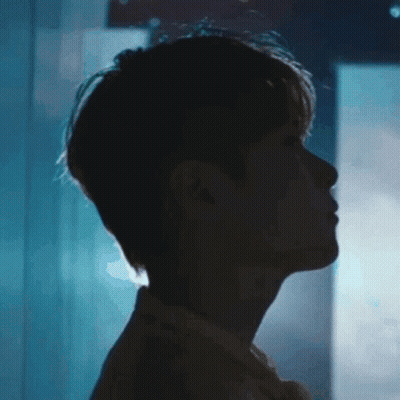A Close Up Of A Man 'S Face In The Dark With A Blue Background . GIF