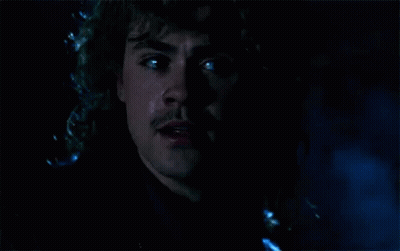A Close Up Of A Man 'S Face In The Dark With Tears Coming Out Of His Eyes . GIF