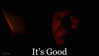 A Close Up Of A Man 'S Face In The Dark With The Words `` It 'S Good '' Written Below It . GIF