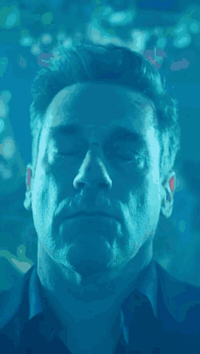 A Close Up Of A Man 'S Face In The Water With His Eyes Closed GIF
