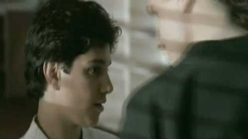 A Close Up Of A Man 'S Face Looking At Another Man 'S Face . GIF