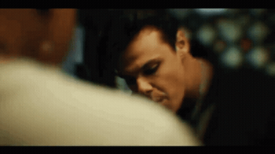 A Close Up Of A Man 'S Face Looking At Another Man 'S Face . GIF