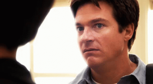A Close Up Of A Man 'S Face Looking At Another Man GIF
