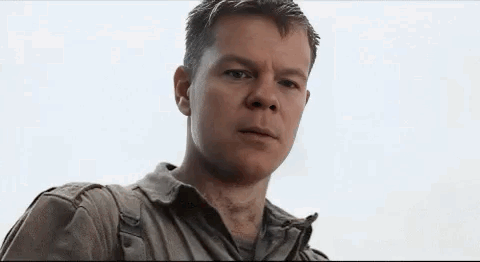 A Close Up Of A Man 'S Face Looking At The Camera . GIF