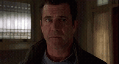 A Close Up Of A Man 'S Face Looking At The Camera . GIF