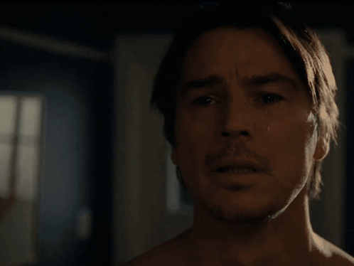 A Close Up Of A Man 'S Face Looking Out A Window GIF