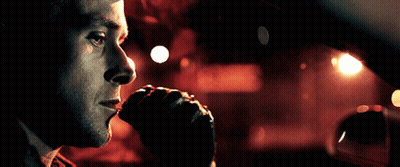 A Close Up Of A Man 'S Face Looking Out Of A Car Window GIF