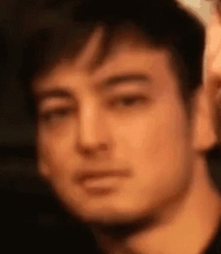 A Close Up Of A Man 'S Face Making A Funny Face . GIF