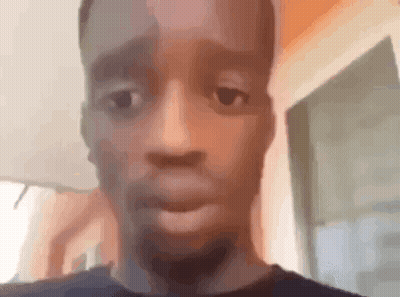 A Close Up Of A Man 'S Face Making A Funny Face While Looking At The Camera . GIF