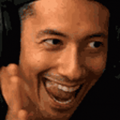 A Close Up Of A Man 'S Face Making A Funny Face With His Tongue Out . GIF