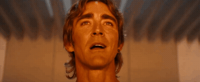 A Close Up Of A Man 'S Face Smiling And Looking Up At The Sky . GIF