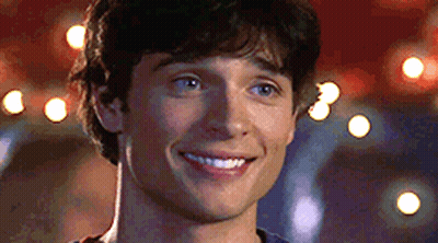 A Close Up Of A Man 'S Face Smiling With A Blurry Background GIF