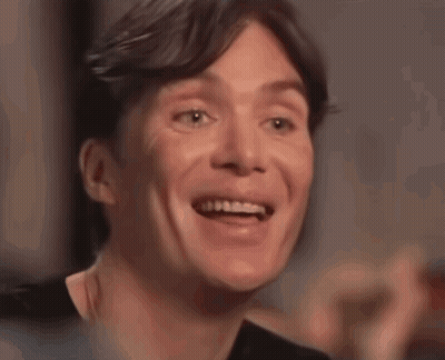 A Close Up Of A Man 'S Face Smiling With His Mouth Open GIF